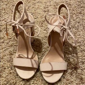 Lace up heels with rose gold tips on the laces.
